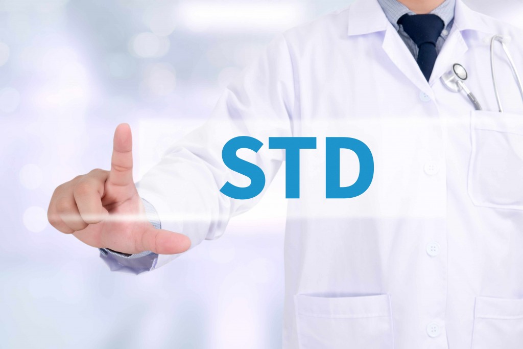 a doctor holds a sign that says STD