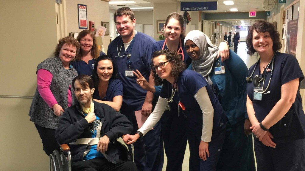 a group of Mayo Clinic nurses and medical staff in hospital hallway with patient Randy Marlow