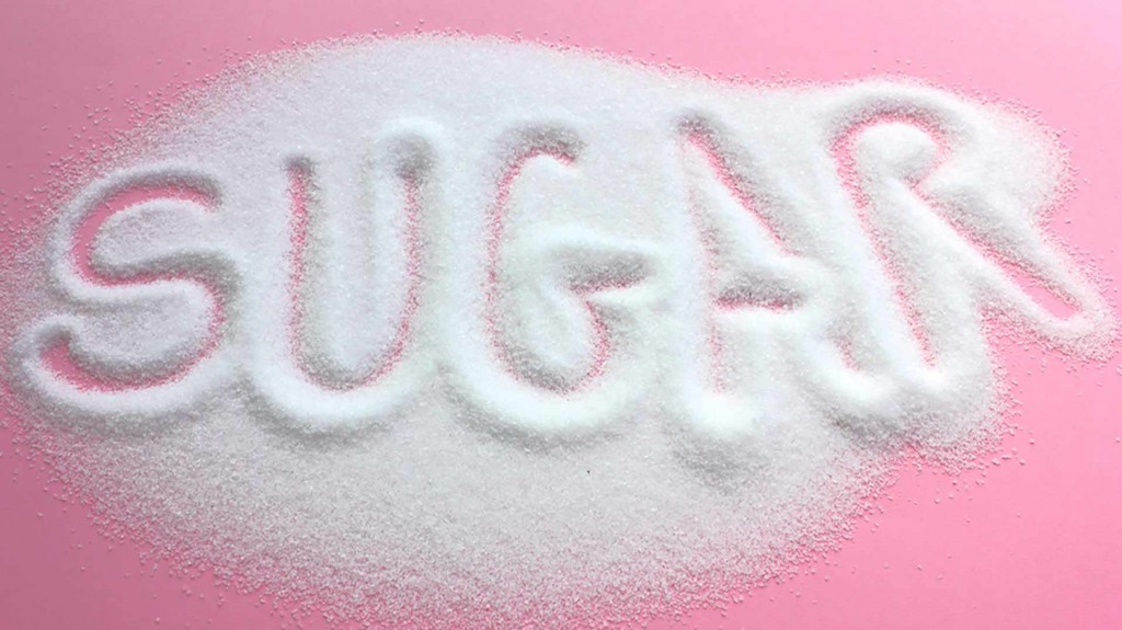 the word sugar written in spilled sugar
