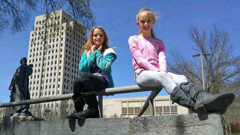 Twins Abby and Belle Carlsen outside in a park