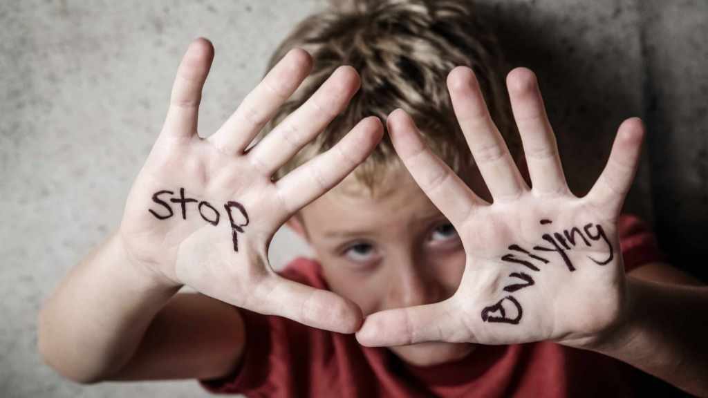 a child with stop bullying written on his hands