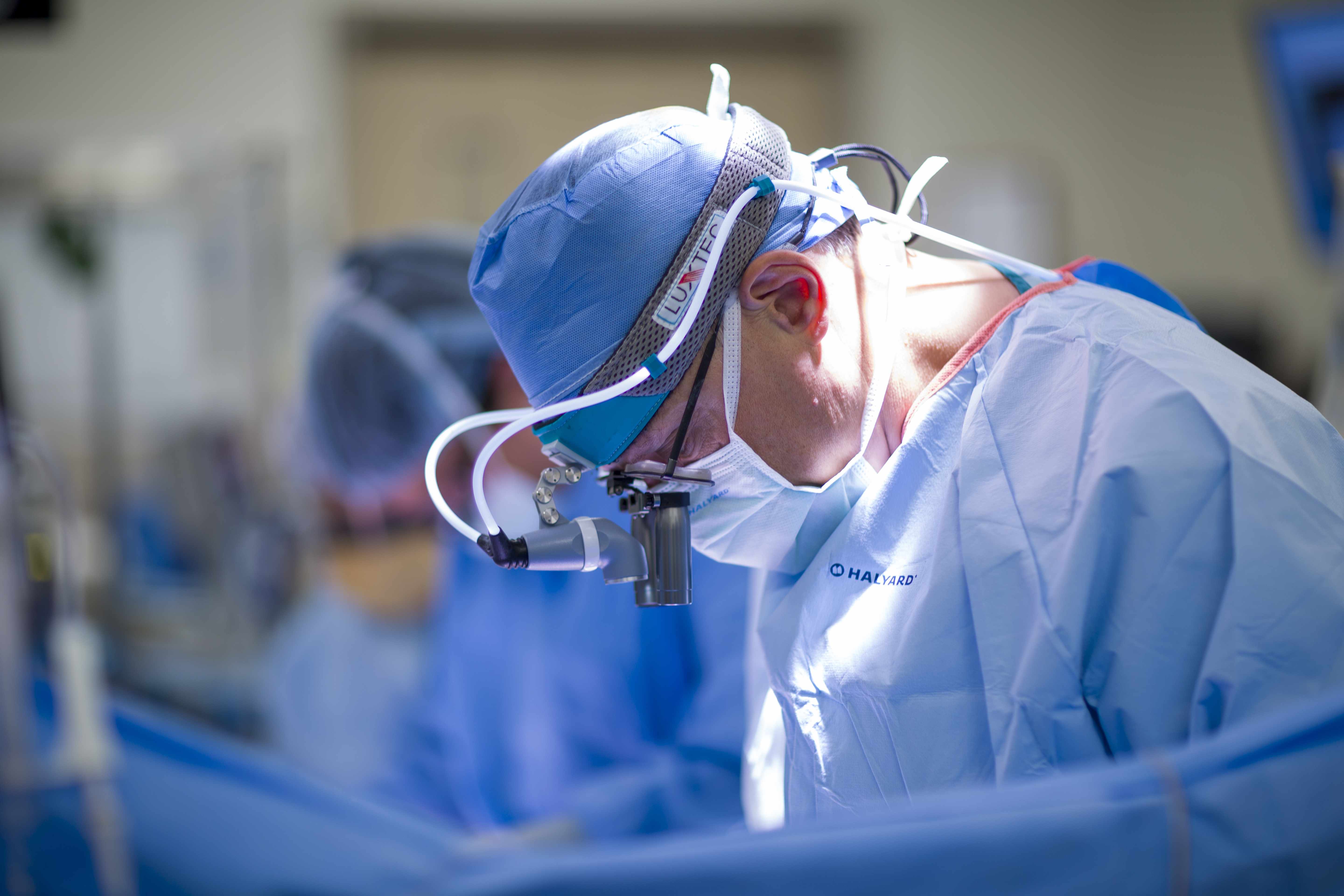 close-up of transplant surgeon performing surgery