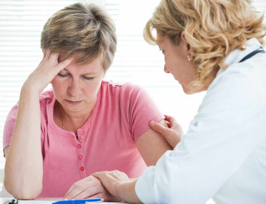 a physician discussing treatment options with a female patient