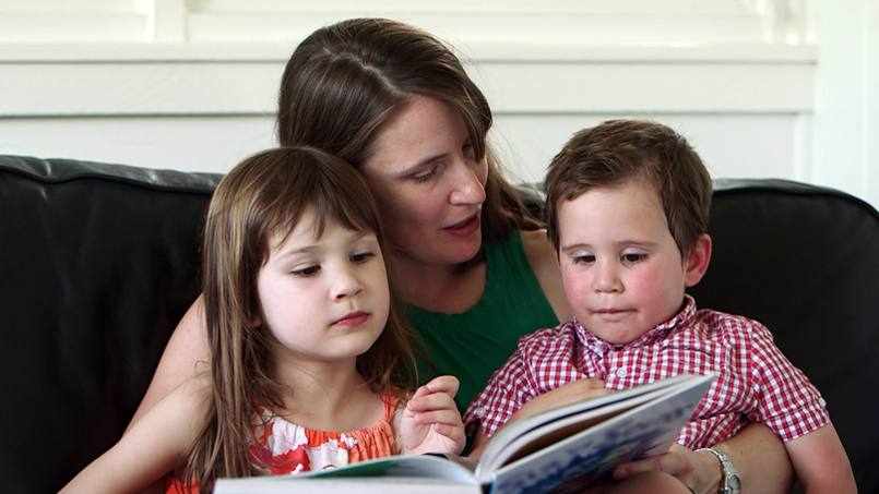 stroke patient Sherry reading a book with her two children