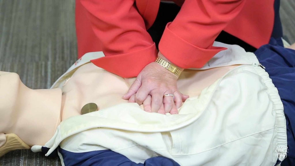 hands giving CPR to a dummy