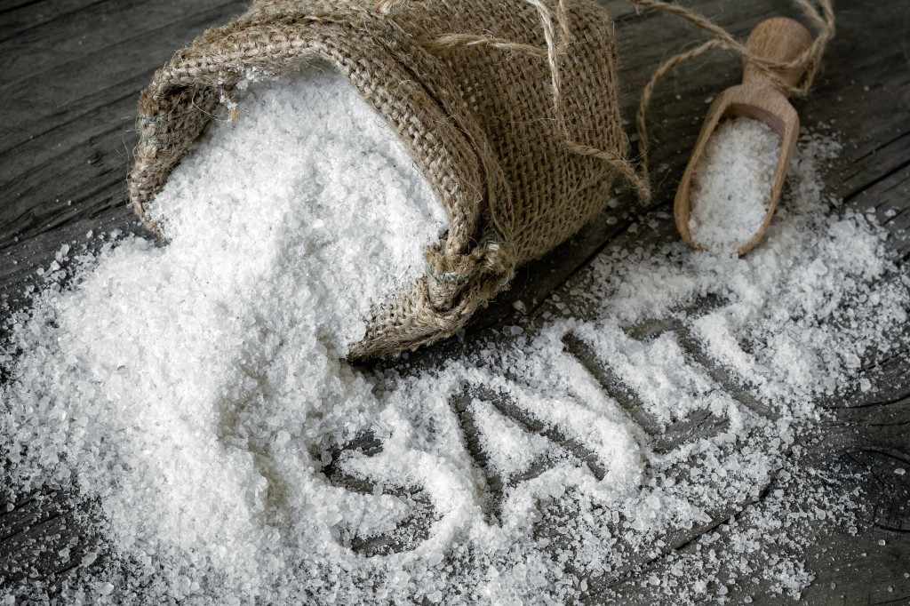 a burlap bag of salt spilled on a table