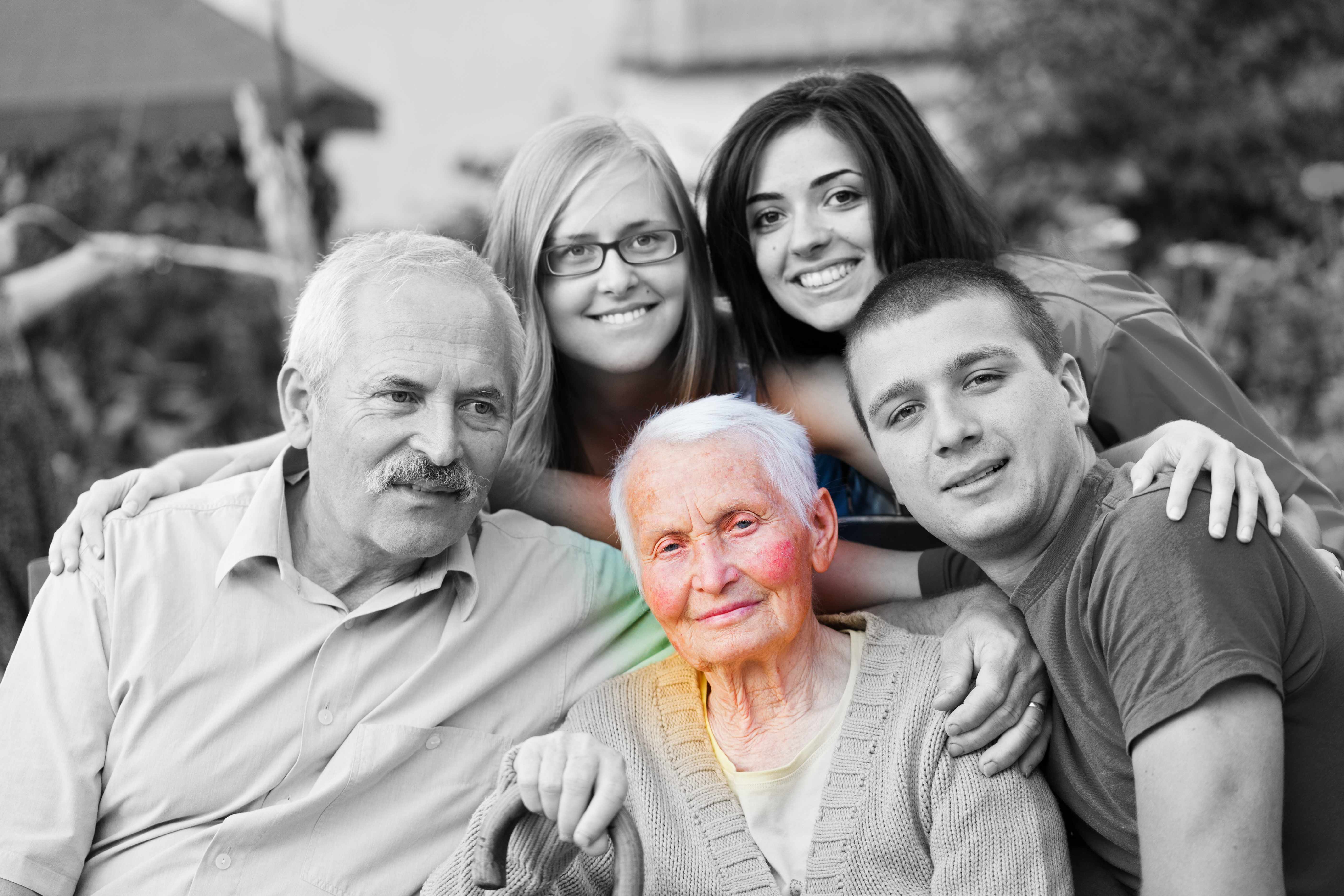a black and white family picture with the older grandmother highlighted