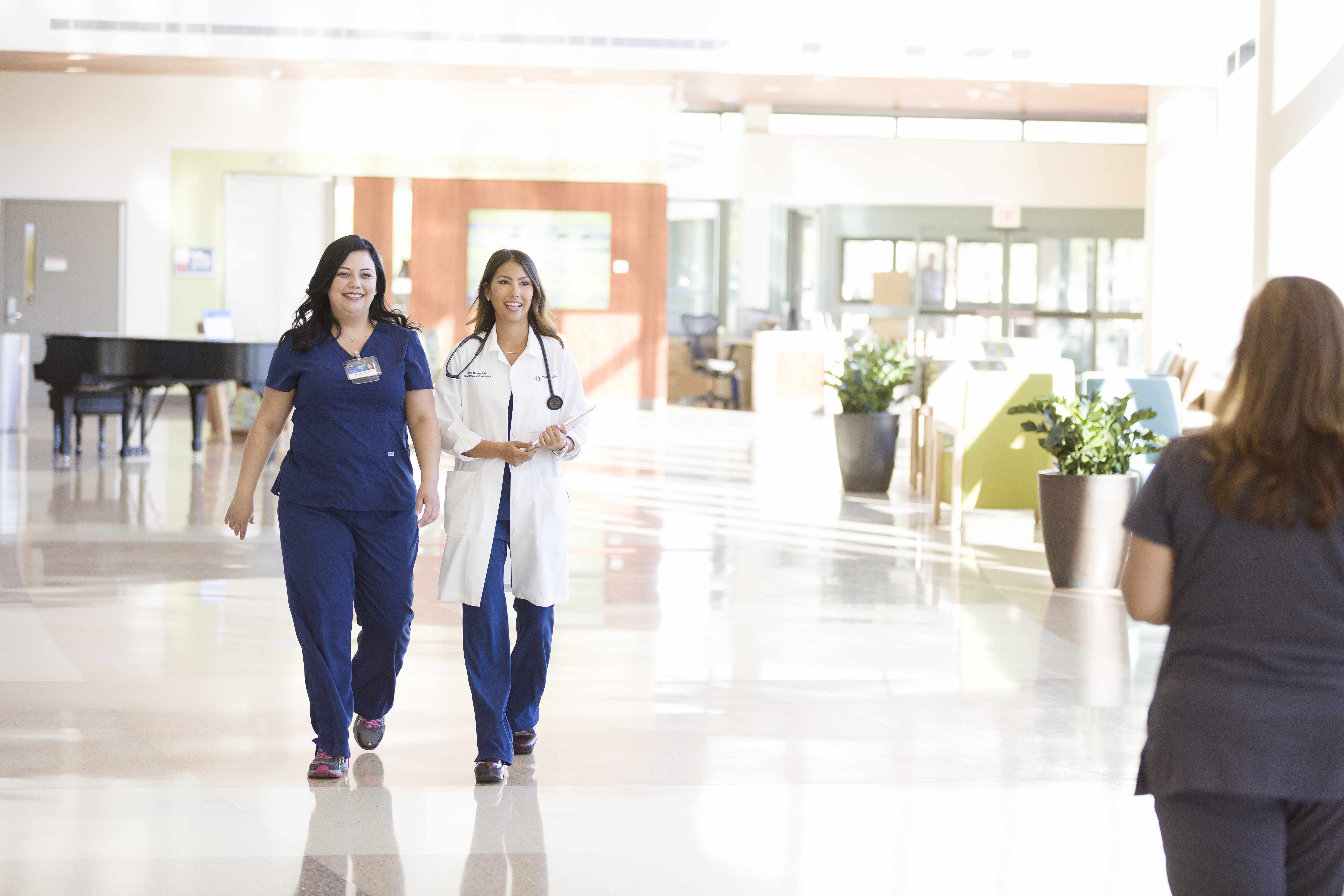 Mayo Clinic medical staff meeting walking in a hospital lobby