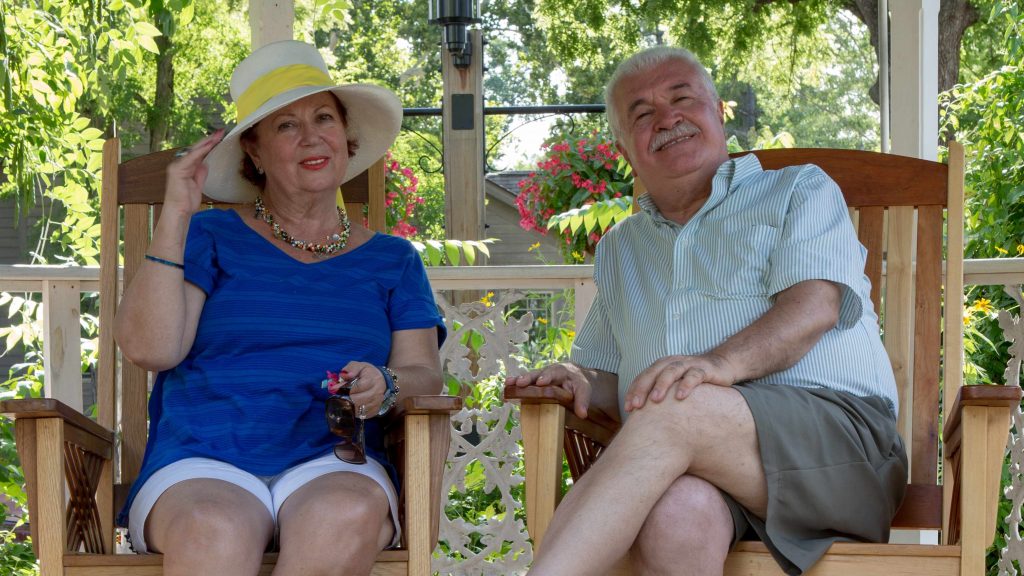 an older woman and man sitting together in a gazebo