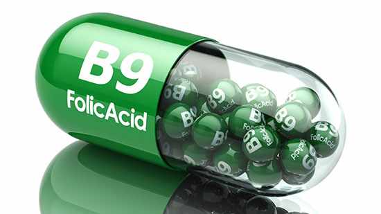 a green pill capsule that reads B9 Folic Acid