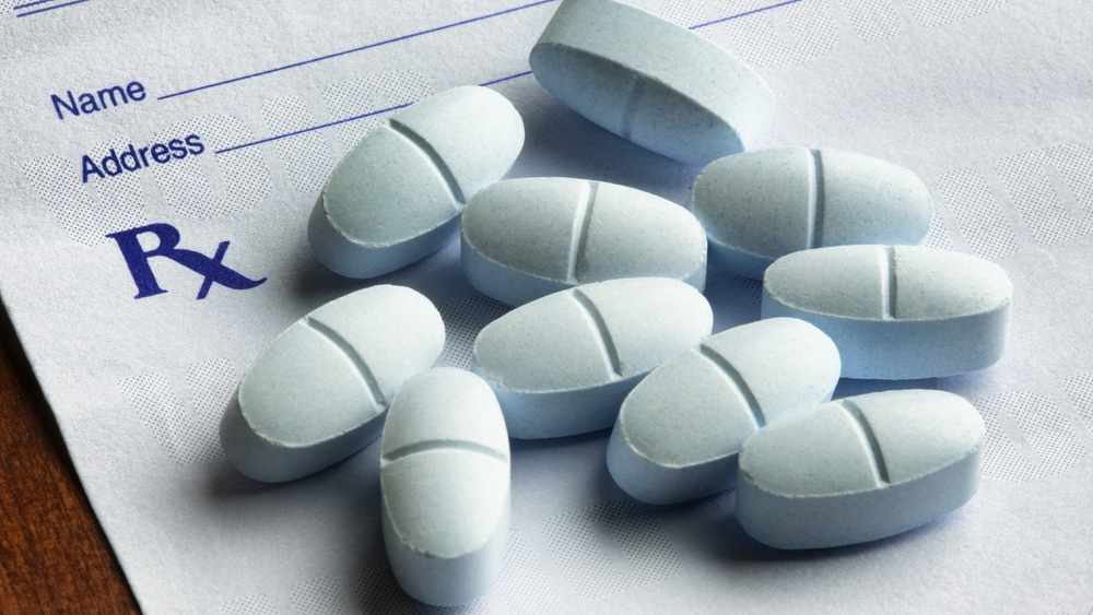Opioid tablets lying on a prescription form
