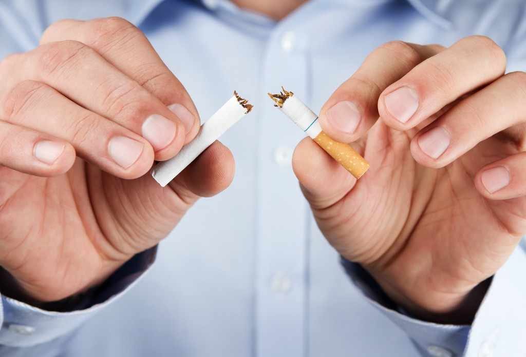 quit smoking, human hands breaking tobacco cigarette