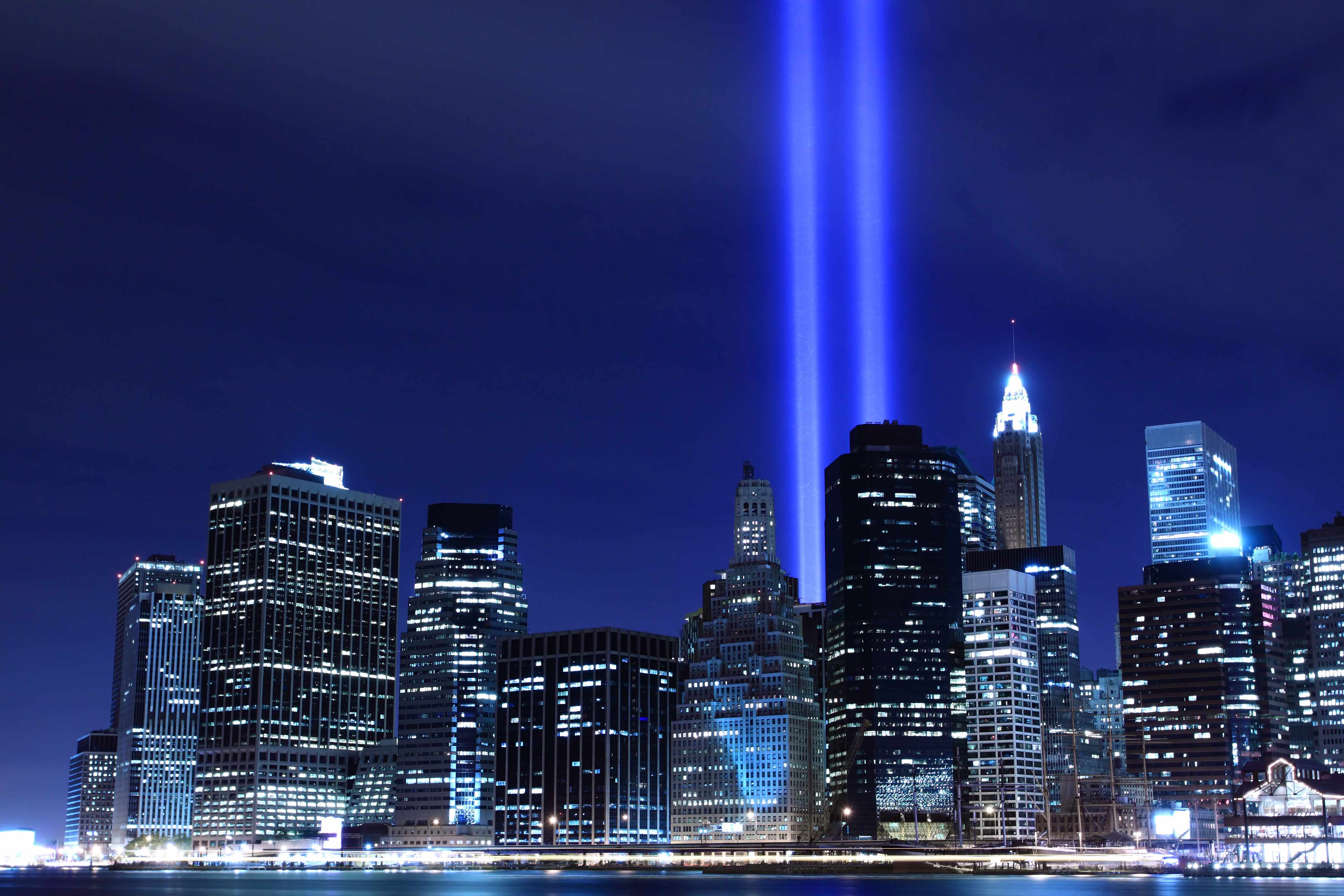 night skyline of New York City with two beams of light for 9-11 remembrance