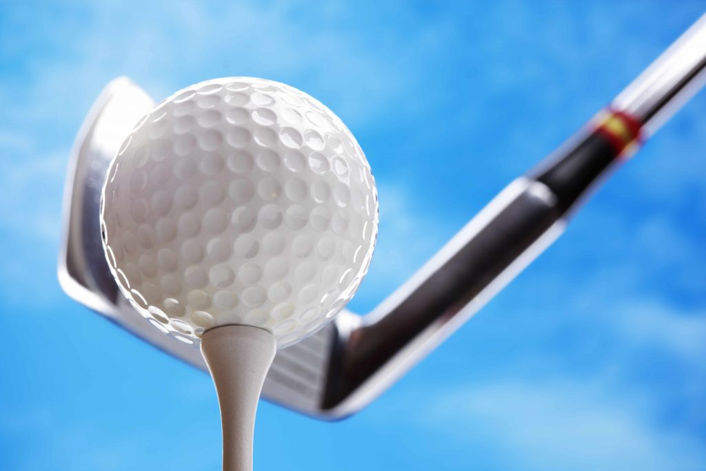 golf club and golf ball with blue sky background