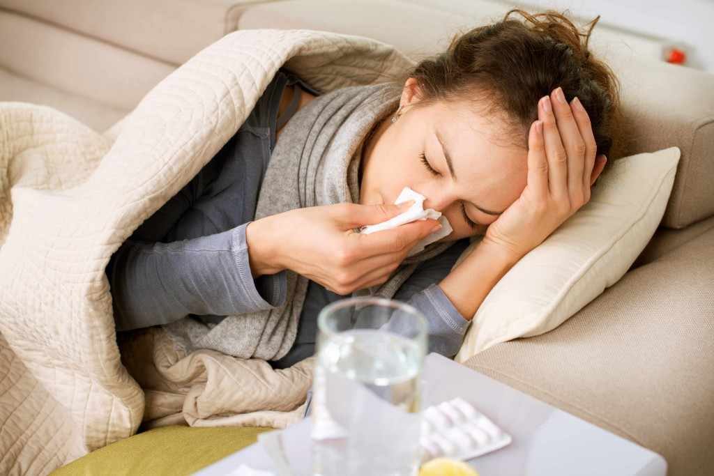 sick woman flu influenza cold tissue sore throat headache virus glass of water