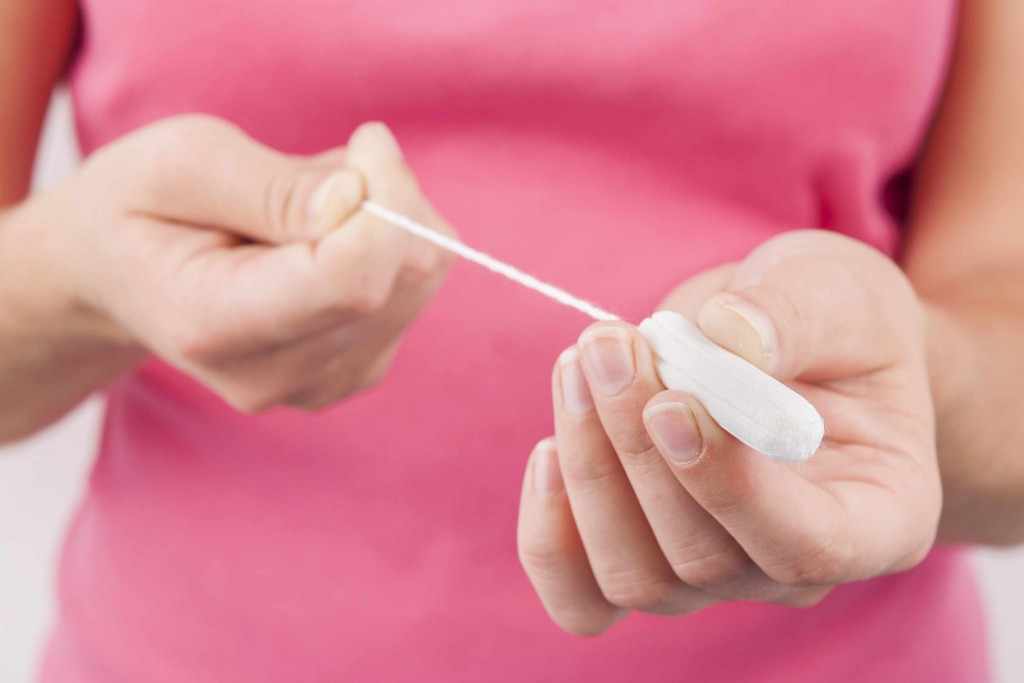young woman holding a tampon menstrual period