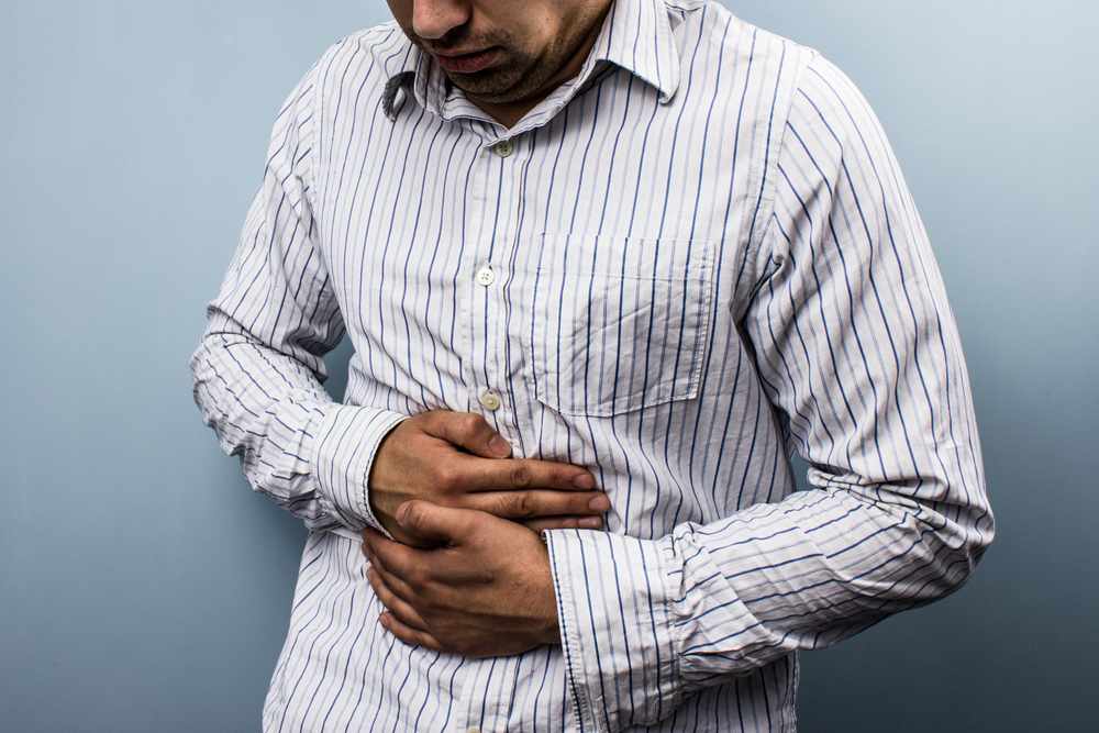 Multi-racial man with stomach pain