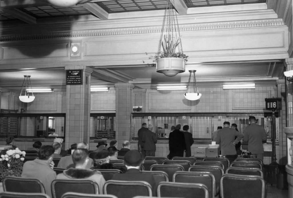 a 1953 photo of the patient registration desk in the Plummer Building