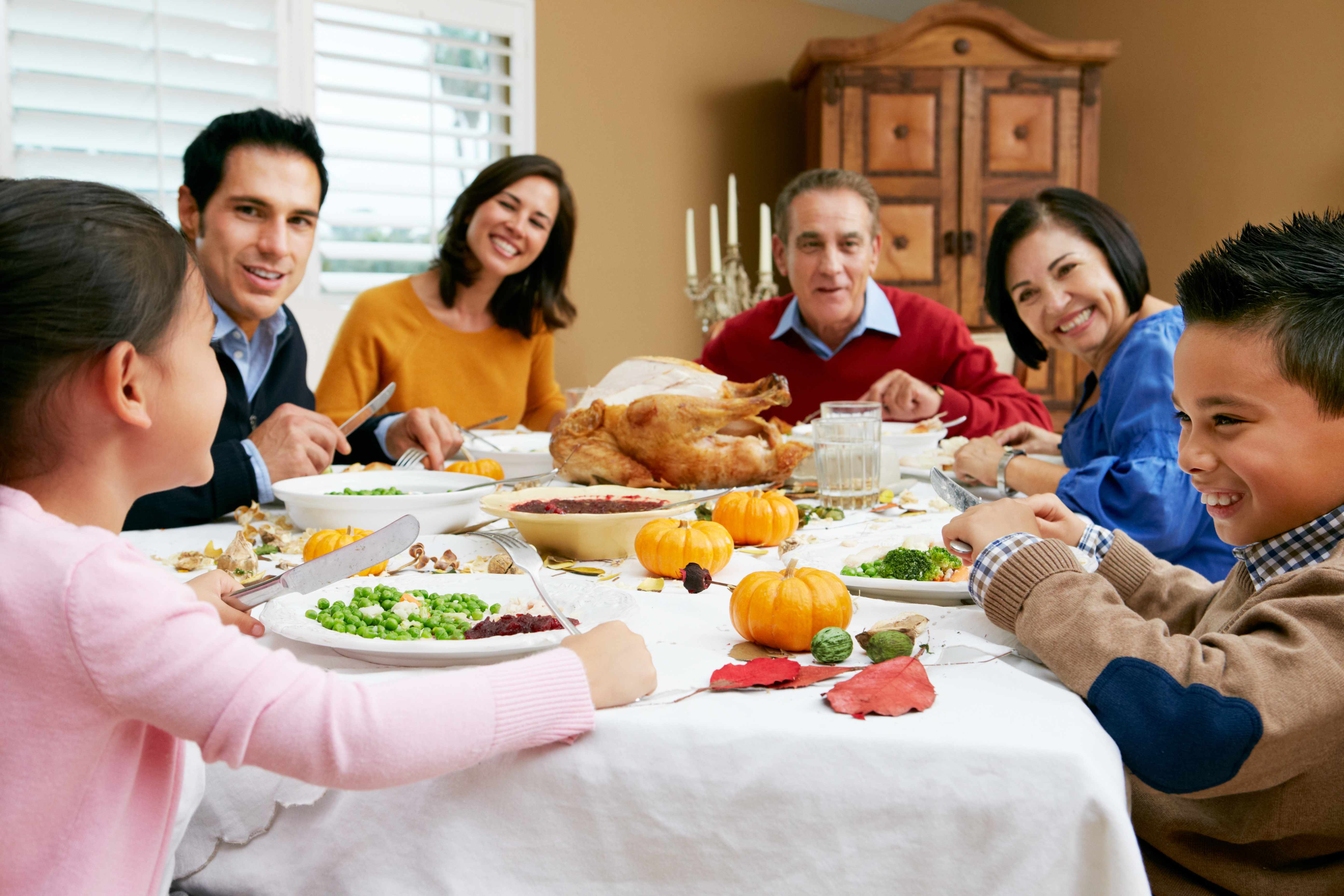 a family around a holiday dinner table laughing and talking