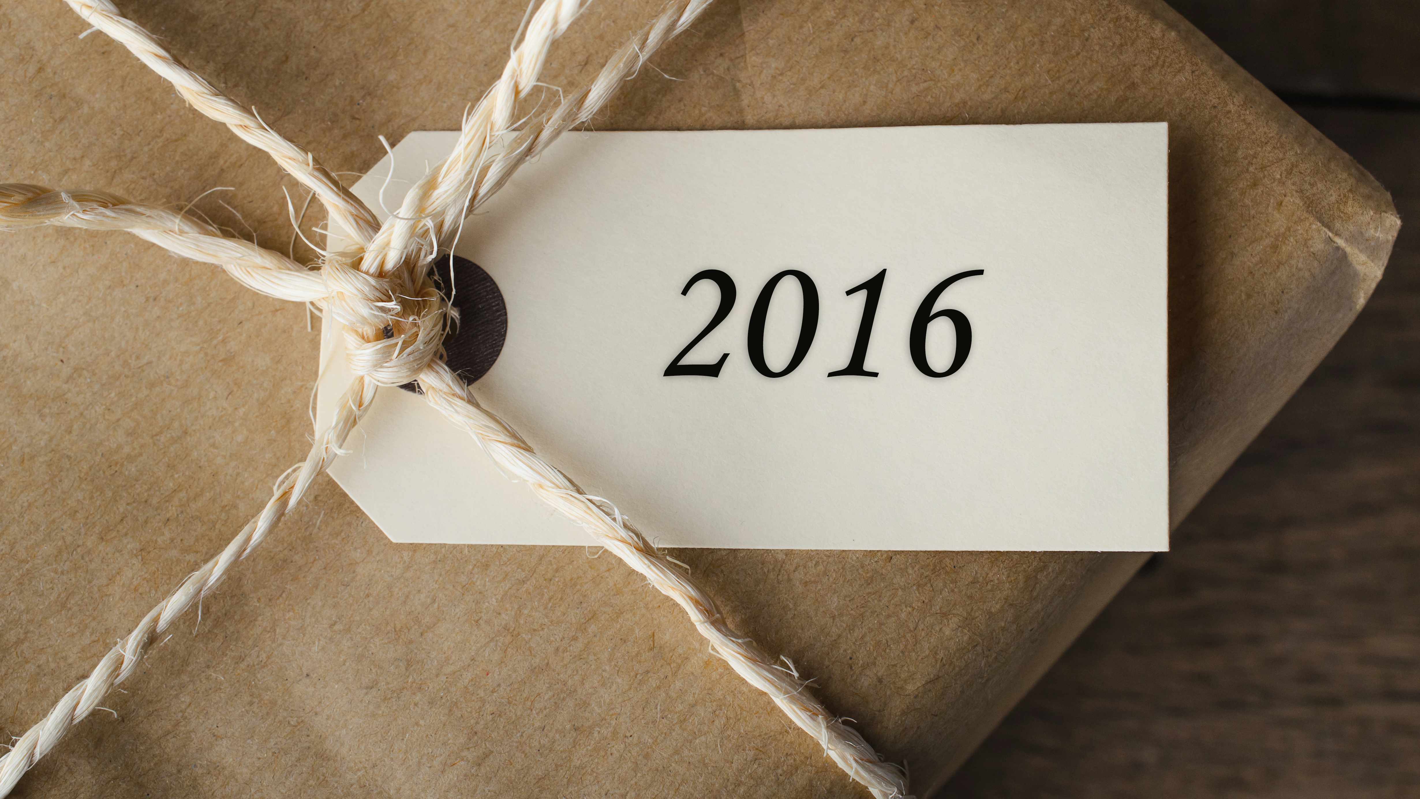 a package wrapped in brown paper and string with a '2016' gift tag