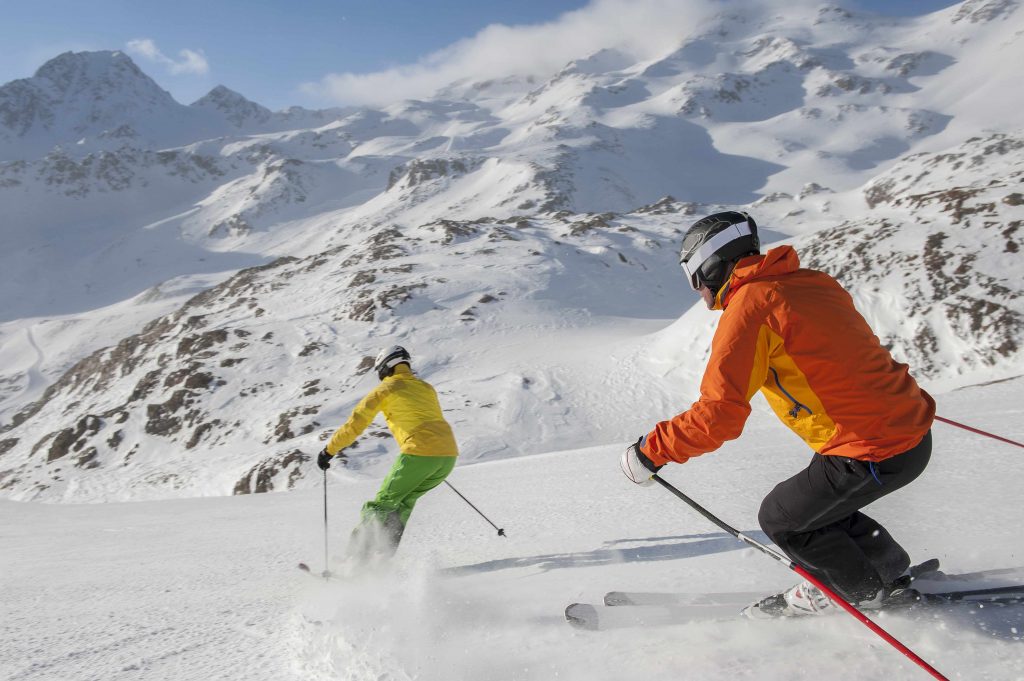 two people skiing down a snow-covered mountainside