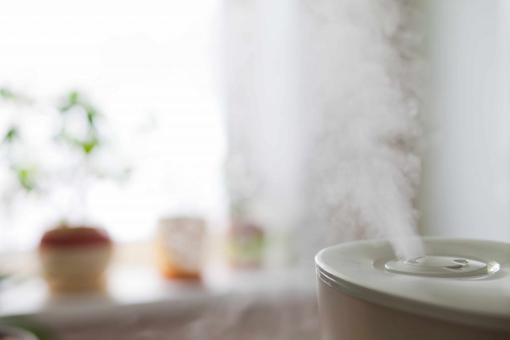 a humidifier emitting moist air into a room