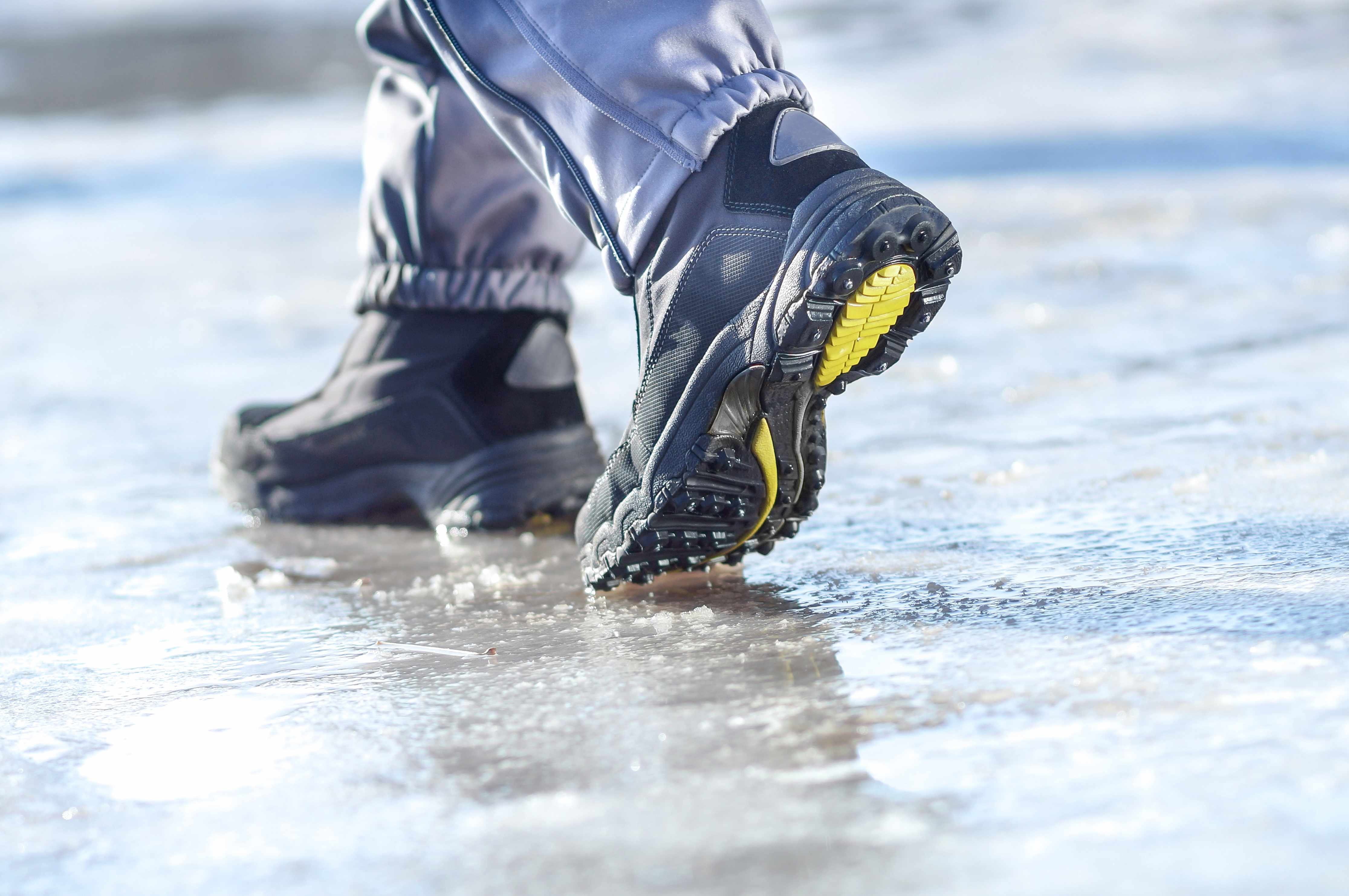 a person in winter boots walking a slippery ice