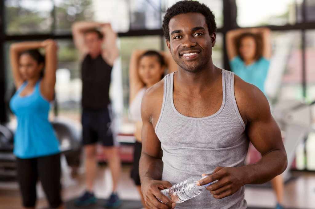 young African-American man in gym for exercise - diversity men's health
