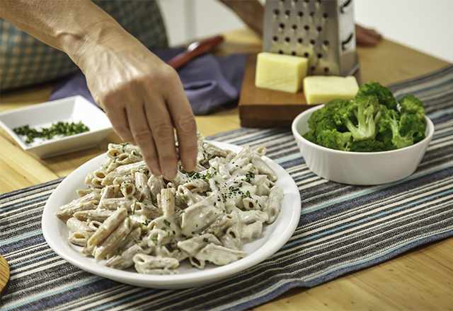 pasta with Alfredo sauce in a white bowl