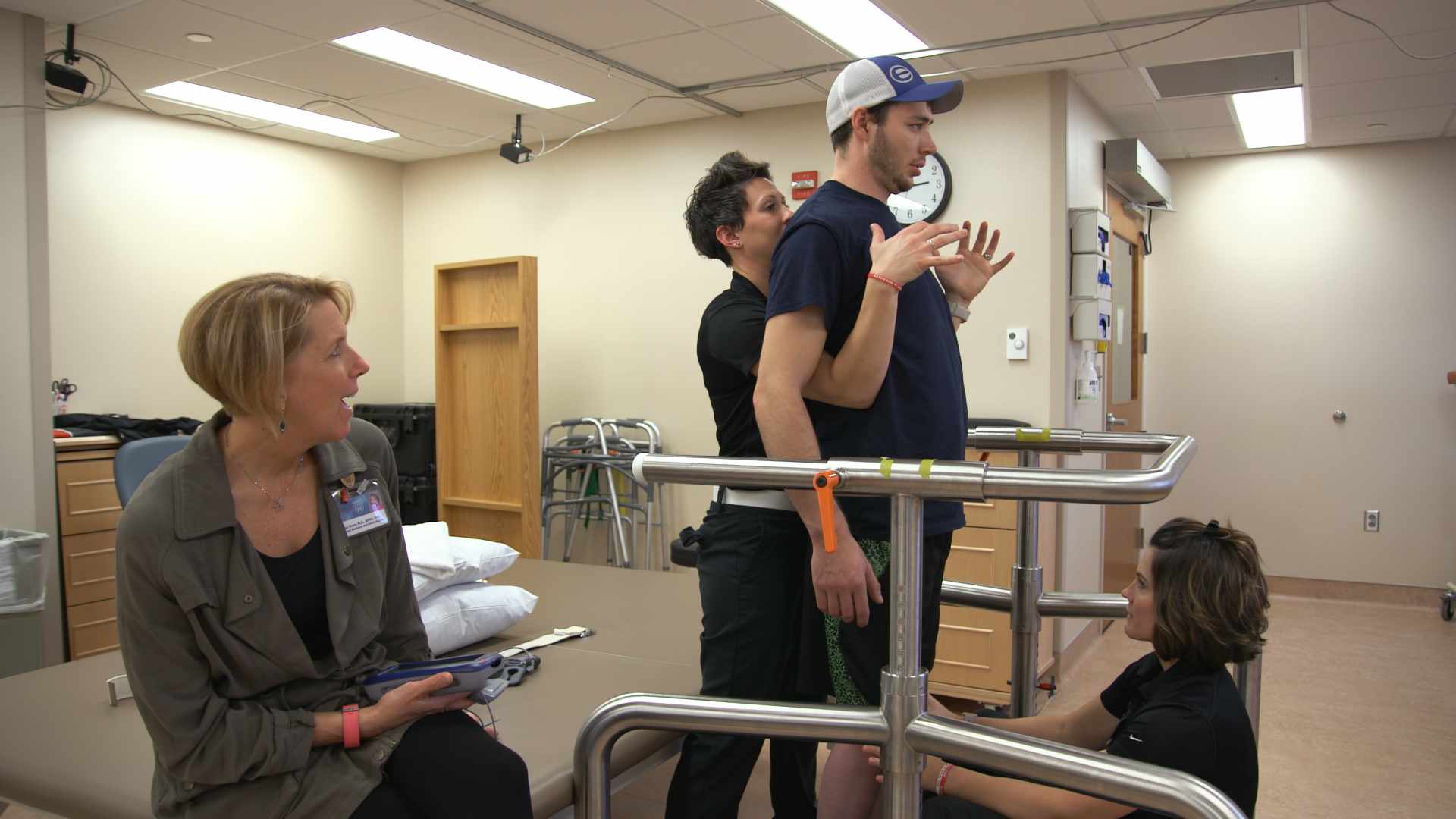paralyzed patient Jered Chinnock standing in physical therapy room 