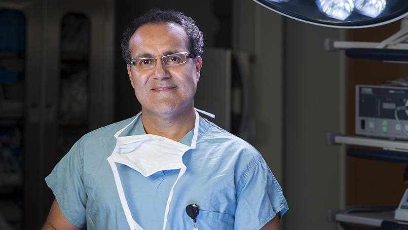Dr. Quinones in his scrubs in an operating room