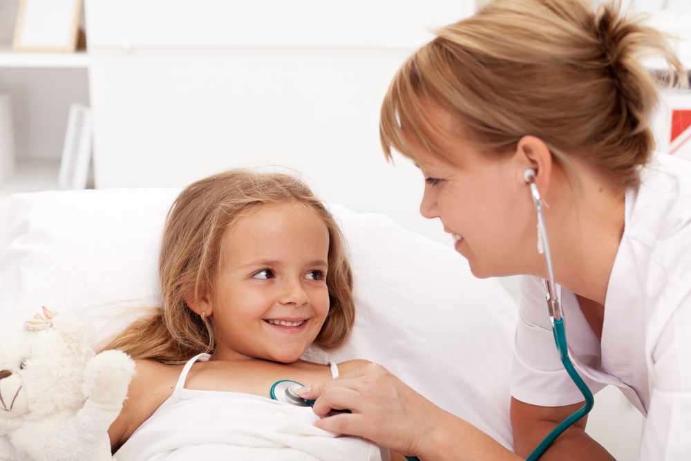 Little girl being checked by friendly health professional with stethoscope