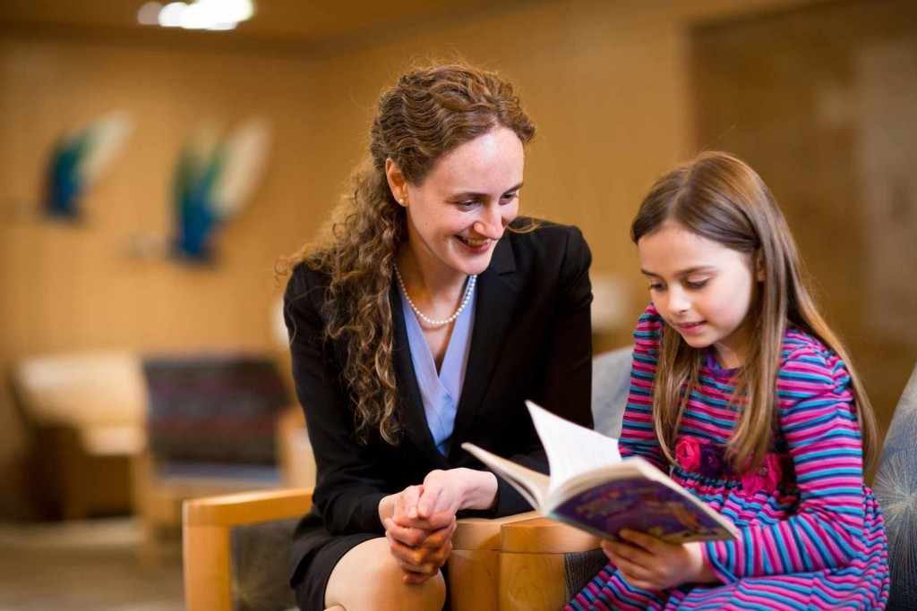 female doctor counselor and young child girl pediatric patient