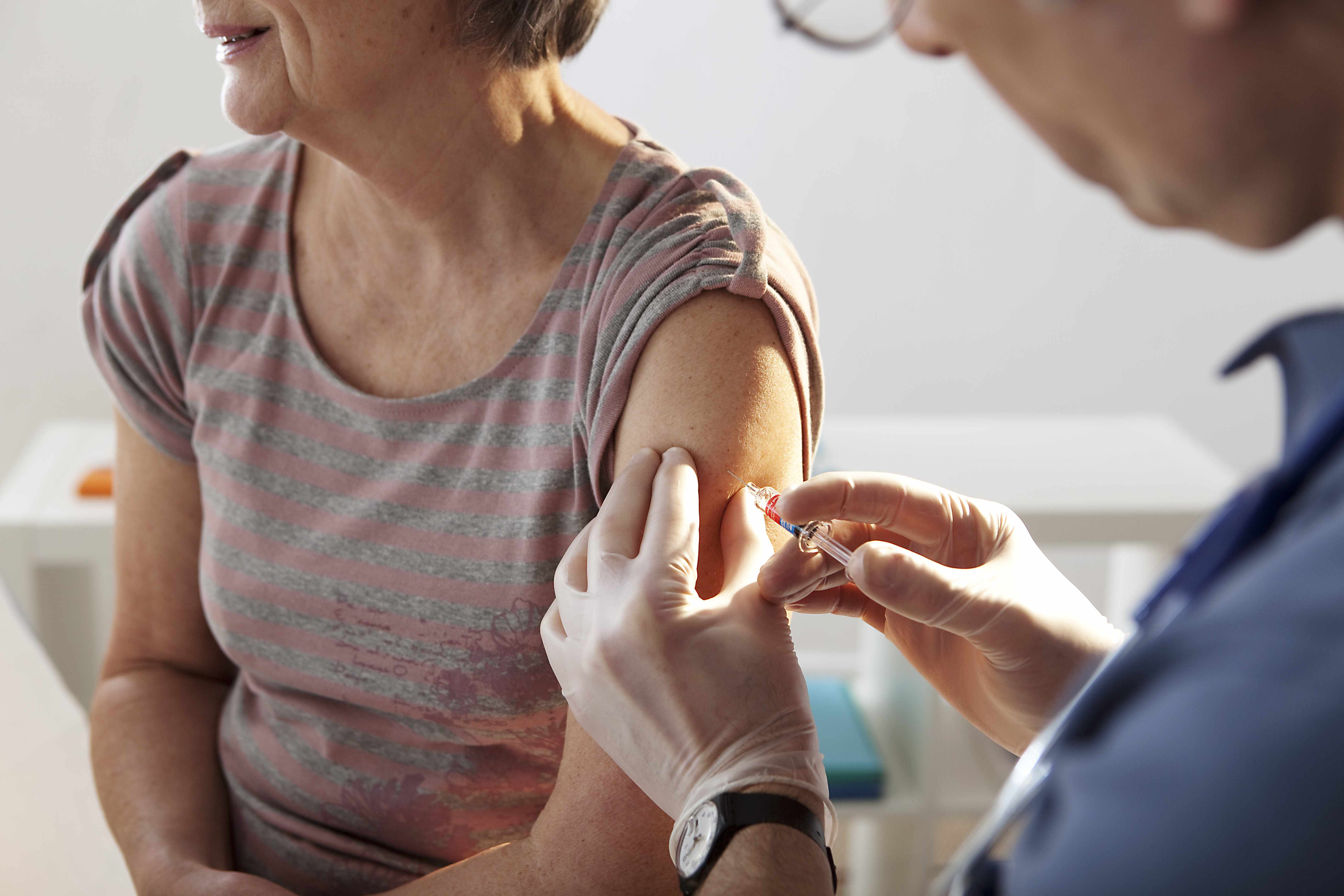 a middle-aged woman getting a vaccination shot