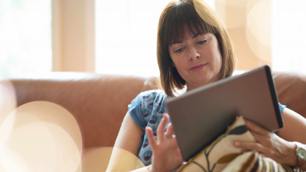 woman looking at digital tablet