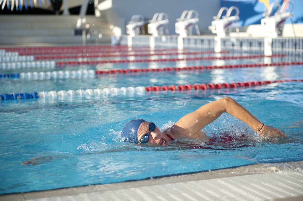 a woman swimming laps in a pool