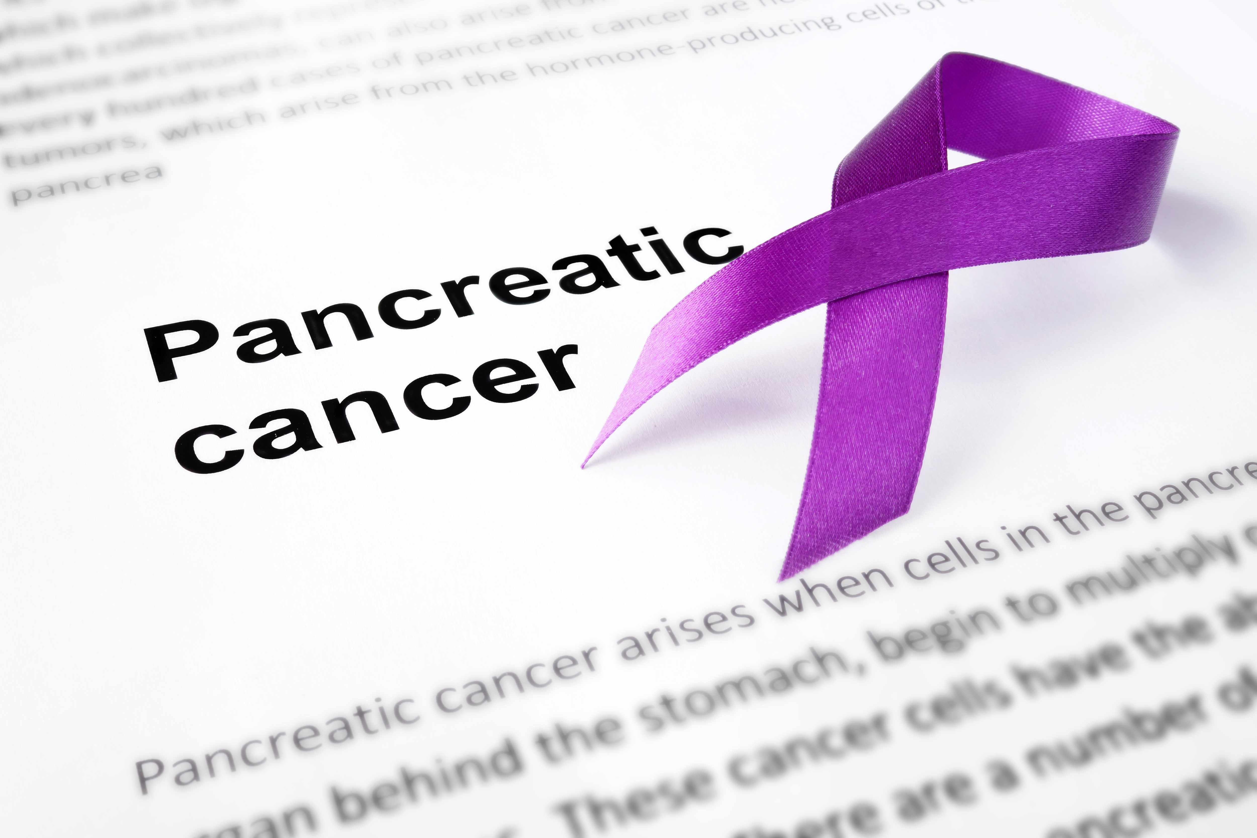 pancreatic cancer words with purple ribbon on paper