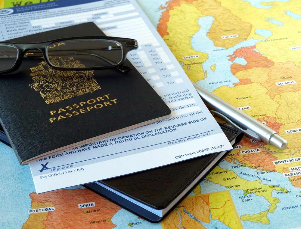 traveling materials with a map, glasses and a passport