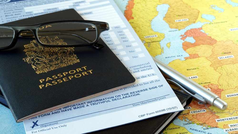 traveling materials with a map, glasses and a passport