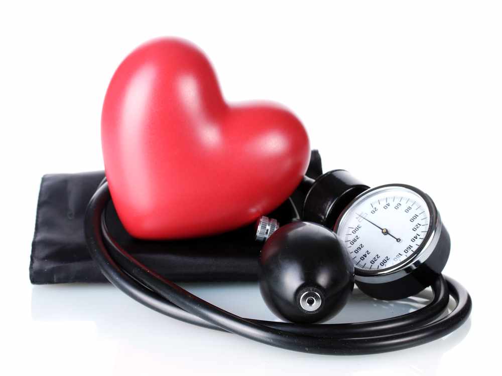 a blood pressure cuff and gauge, with a red plastic valentine <a href=