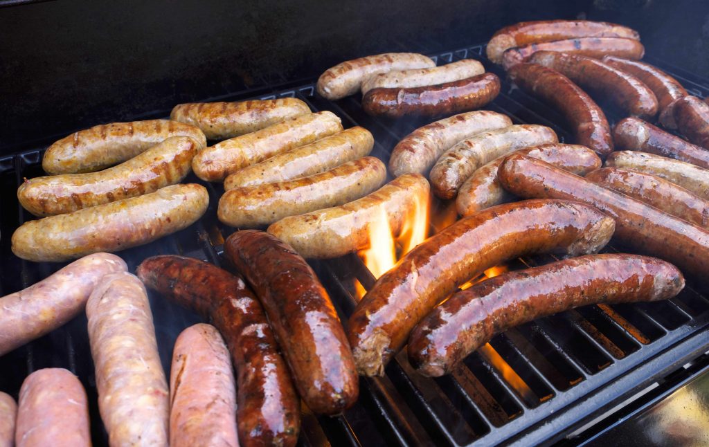 processed meat on a grill, hot dog sausages
