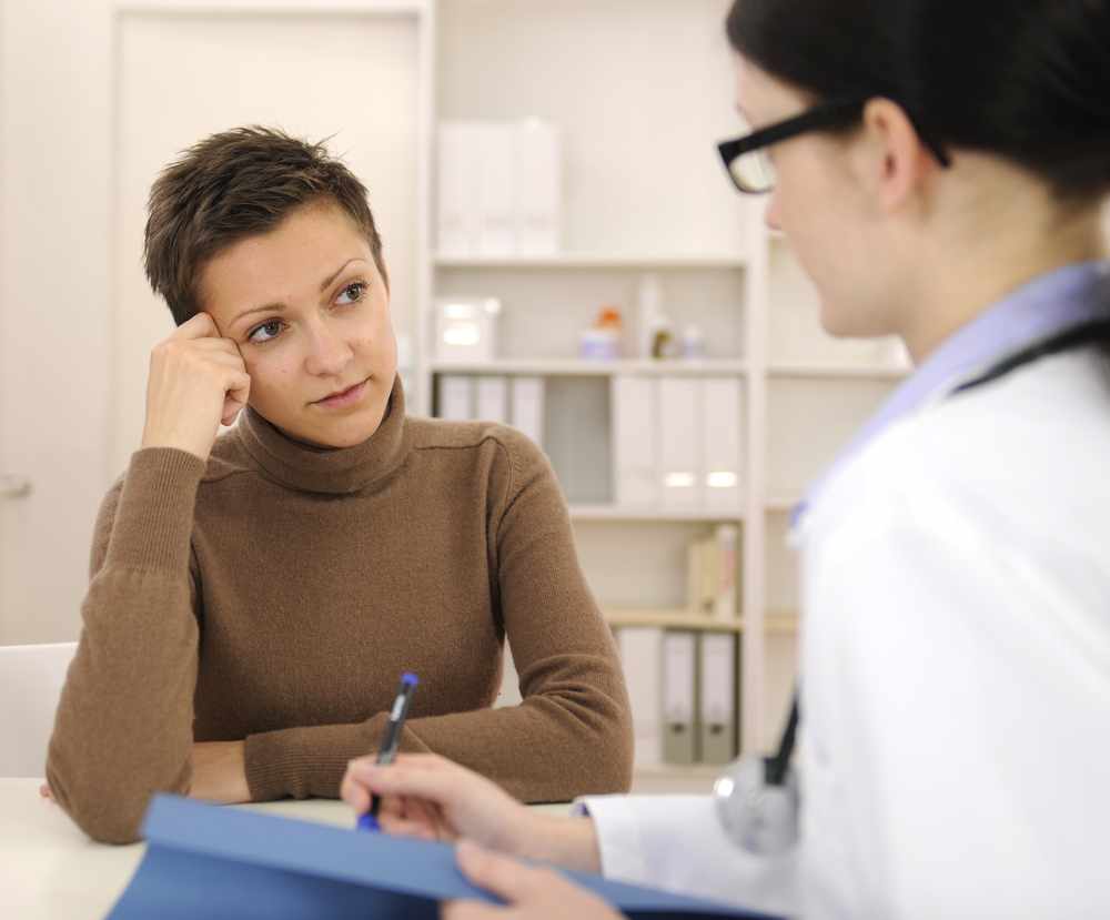 worried female patient at female health care provider's office during consultation