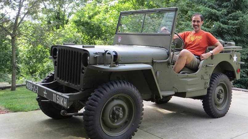 Mayo Clinic cardiologist Gurpreet Sandhu, M.D., Ph.D. in a WWI jeep he refurbished
