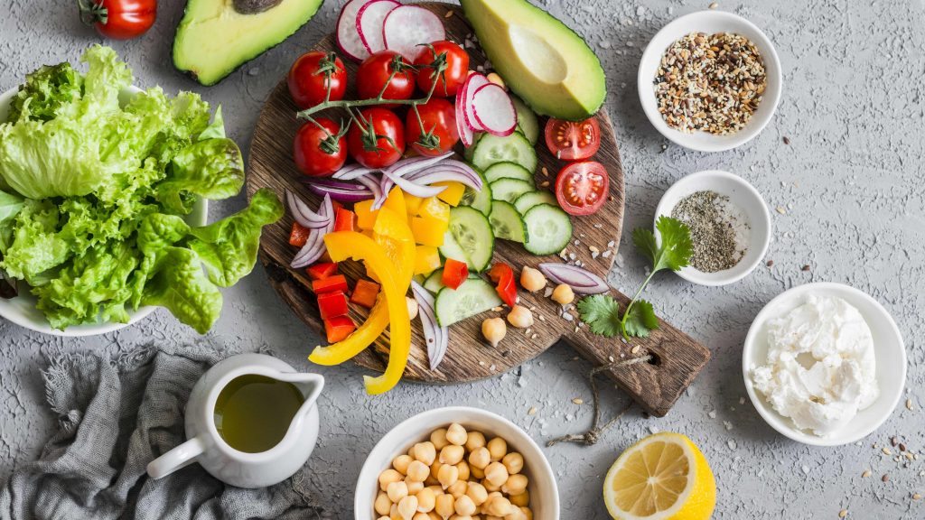 Ingredients for a healthy vegetable salad with lettuce, chickpeas and avocados