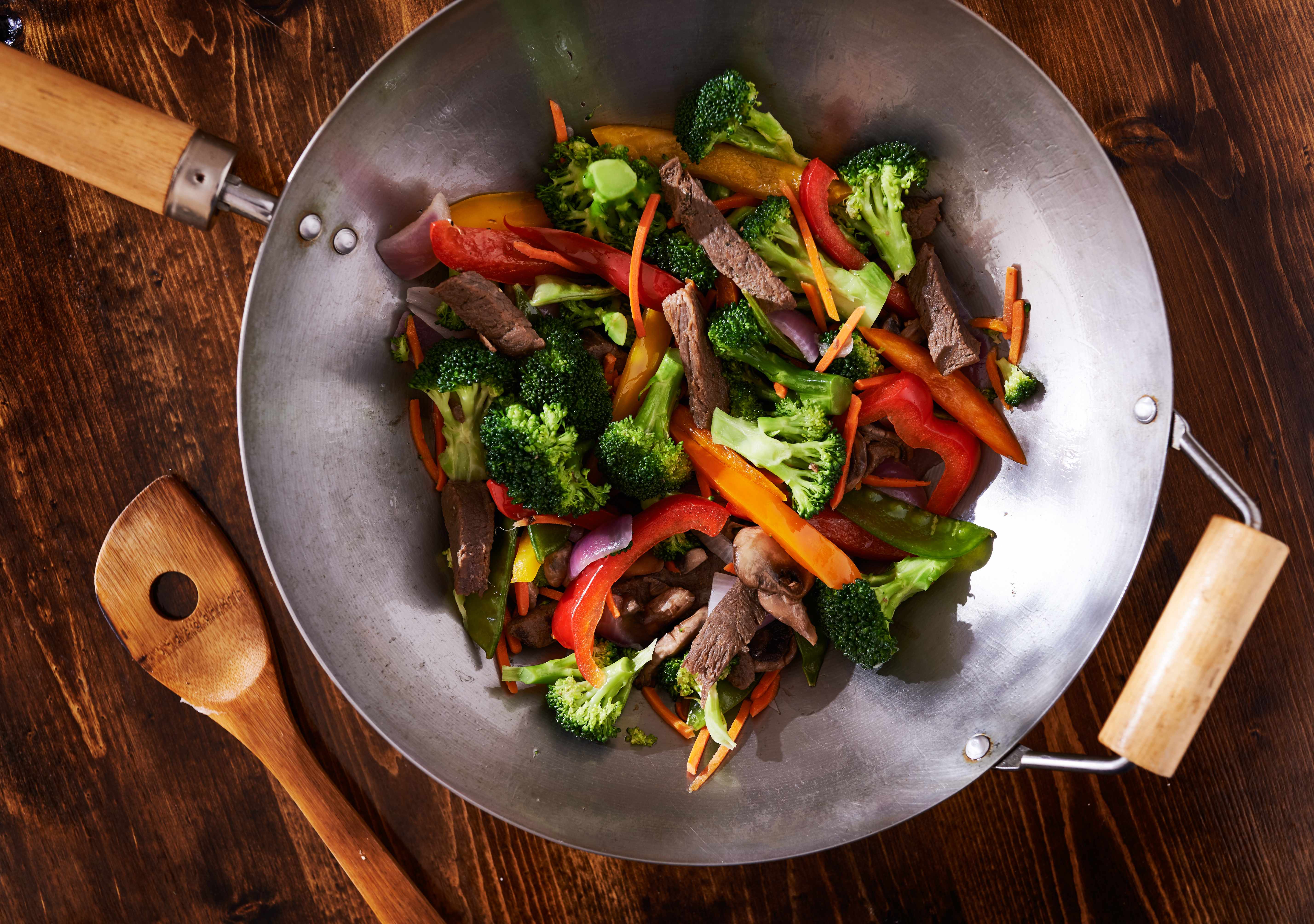 beef and vegetables in a stir fry wok