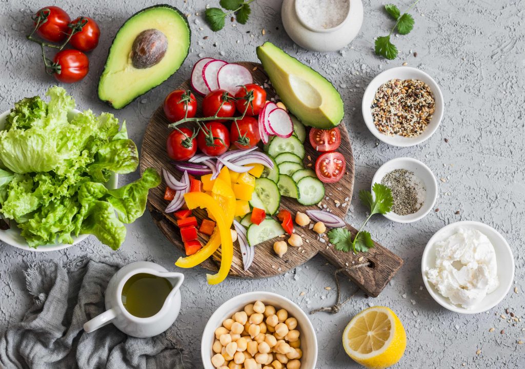Ingredients for a healthy vegetable salad with lettuce, chickpeas and avocados
