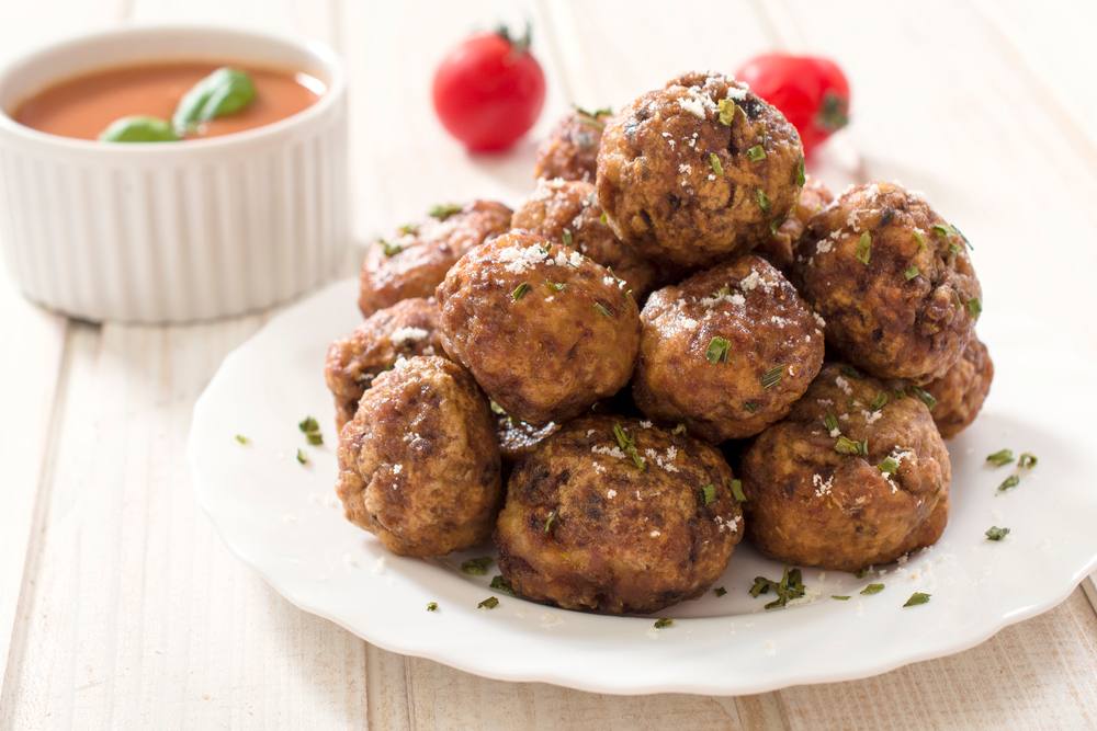 cooked meatballs stacked on a plate