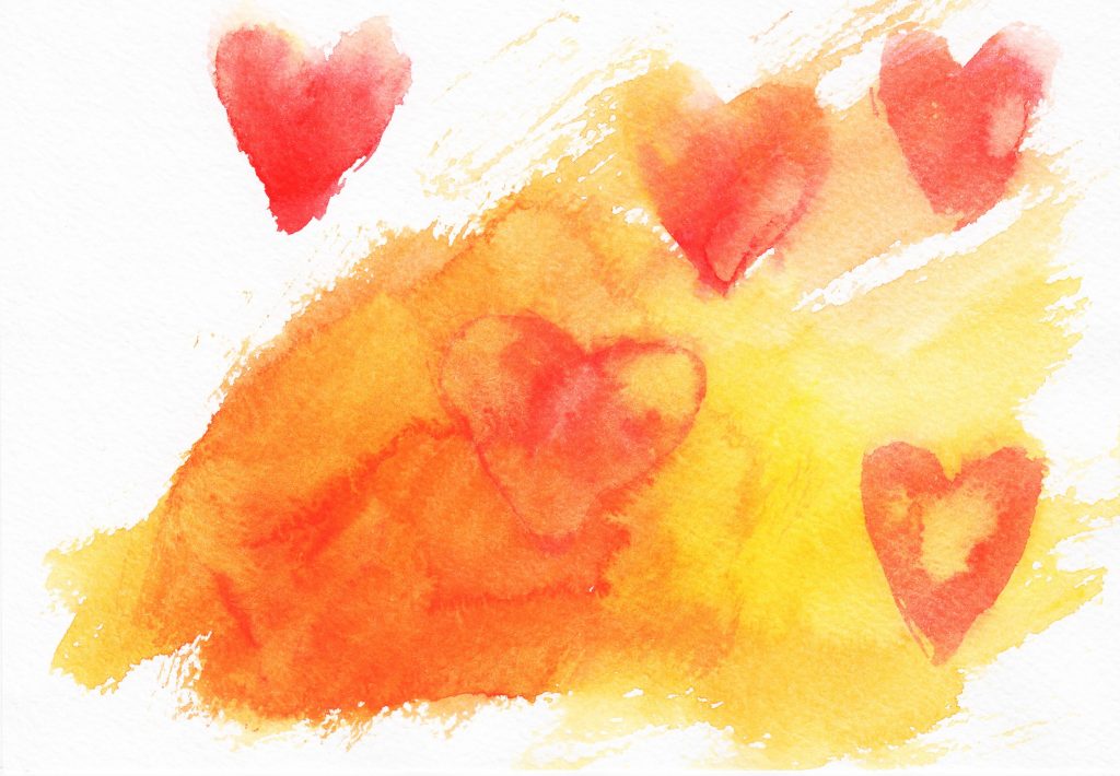 a watercolor graphic of a hearts in gold, orange and red