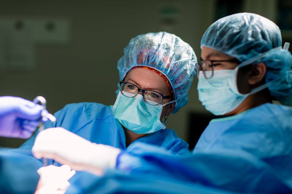 two female physicians performing surgery