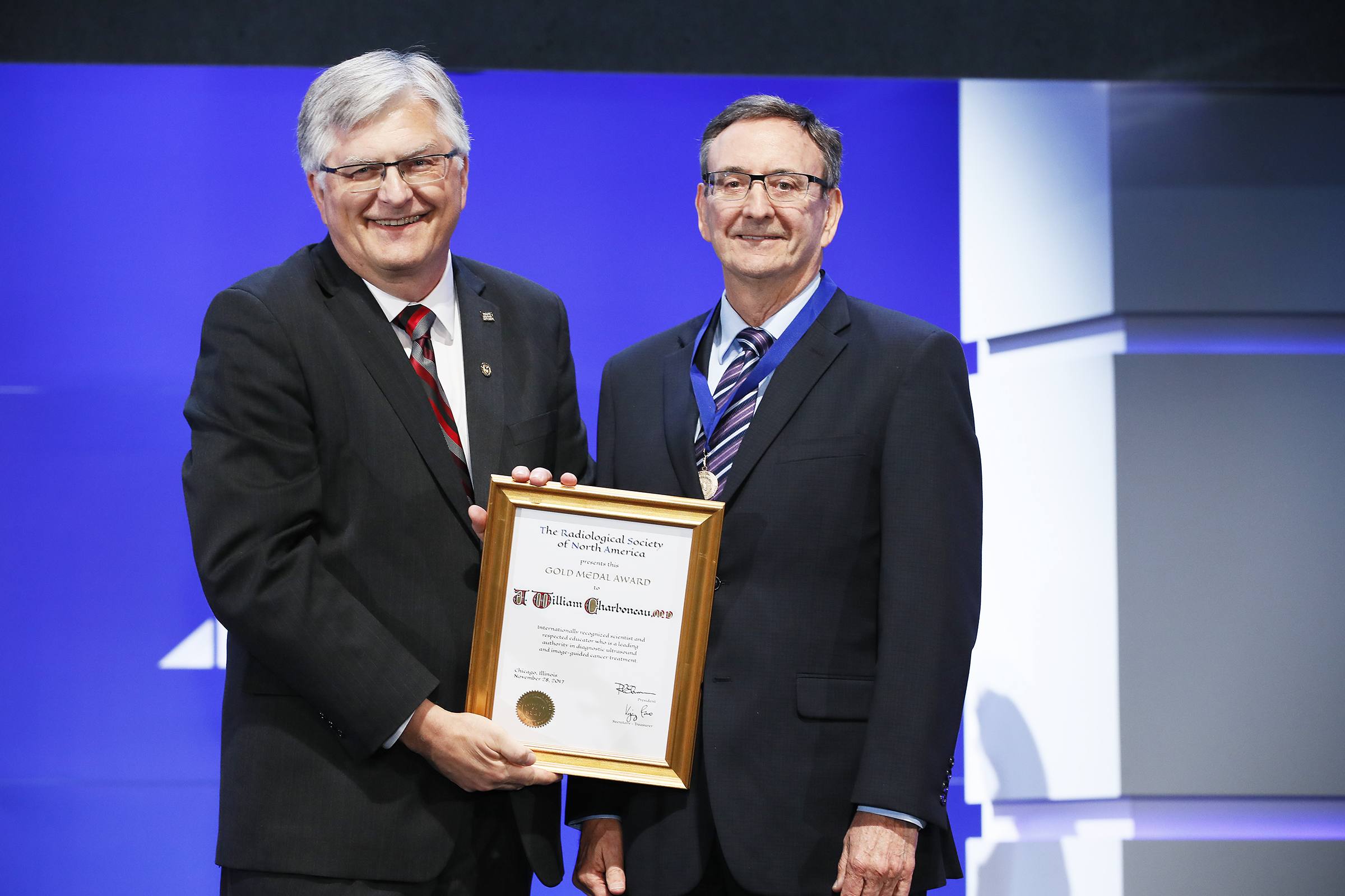 Photo of Dr. J. William Charboneau and award